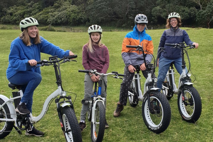 4 kids riding e bikes on the park