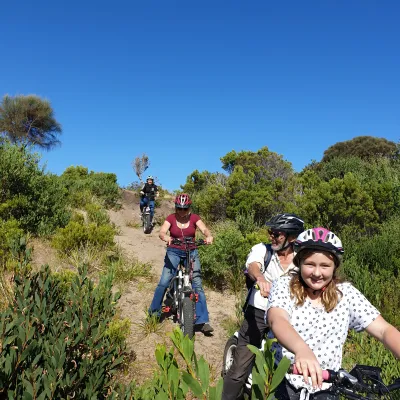 People riding electric bike on a sunny day