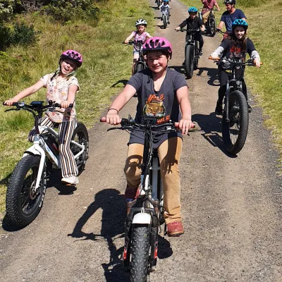 a group of people standing around a motorcycle